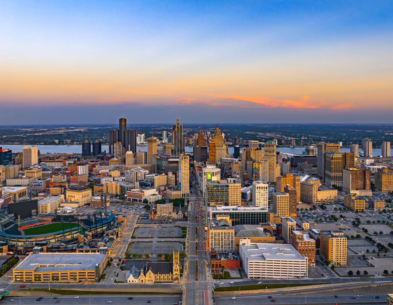 Aircraft in an open hangar with the Detroit skyline beyond