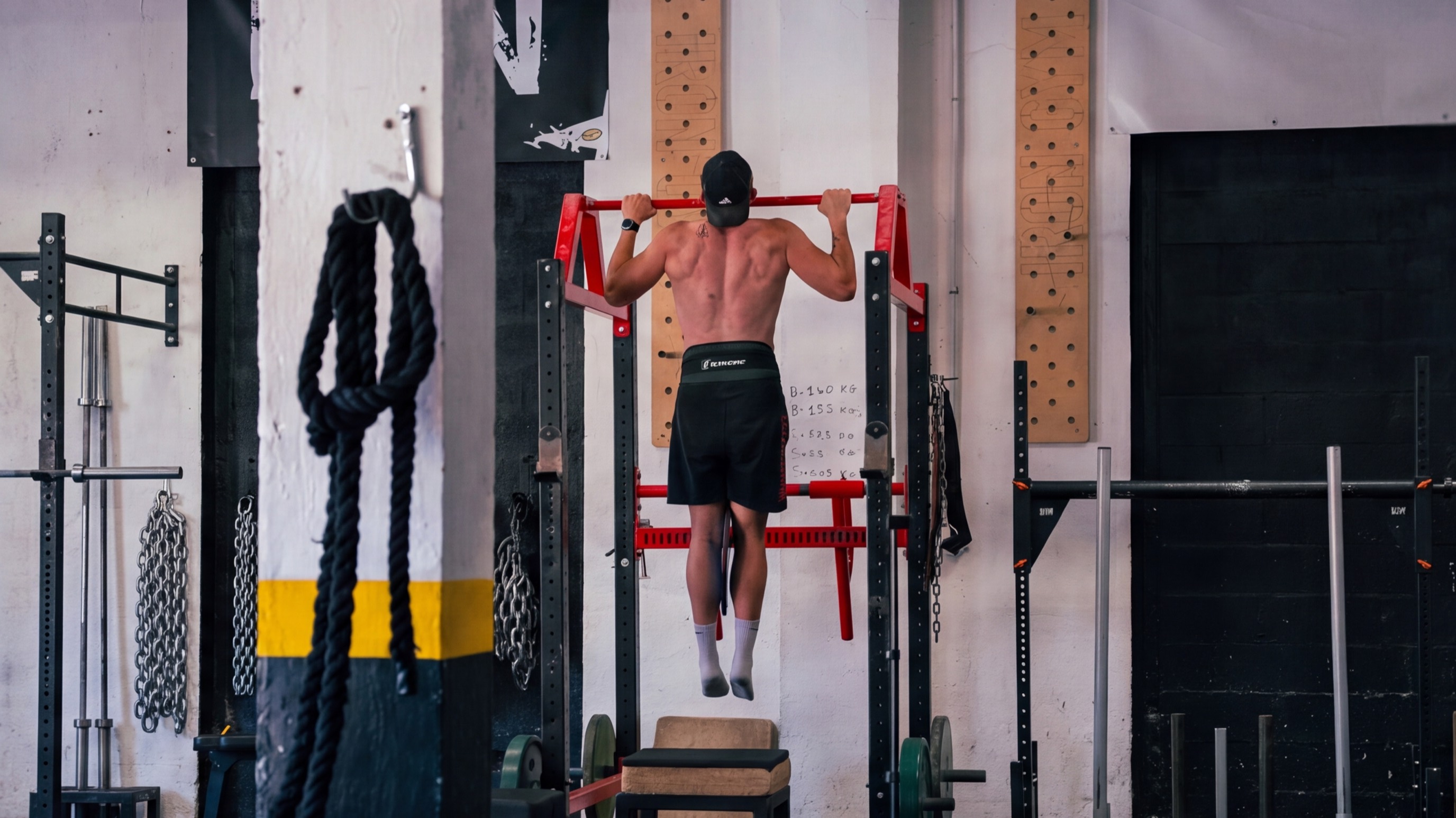 Traction à la barre fixe devant les pegboards IRONGYM