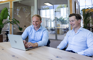 Make & Partners team members collaborating at a laptop