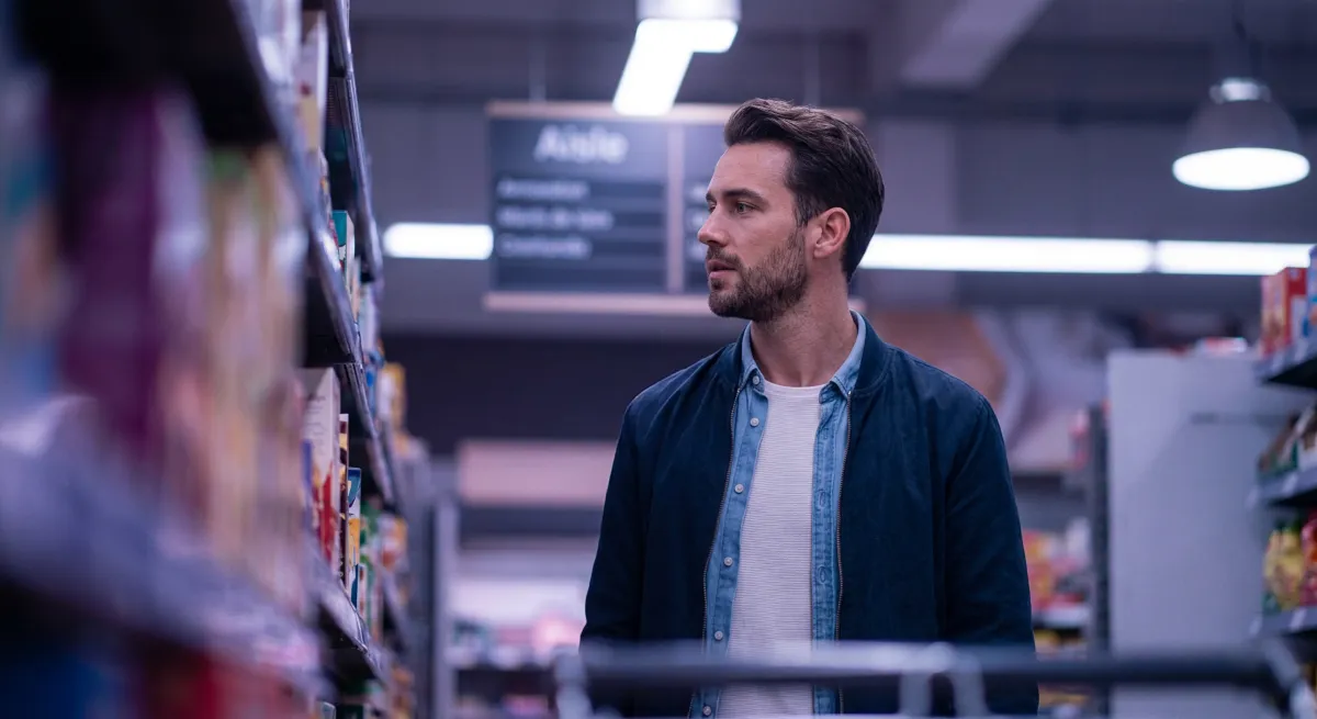 Shopper browsing a supermarket aisle