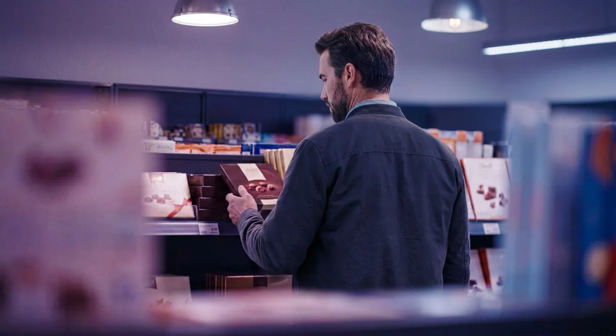 Shopper picking up a product from a shelf