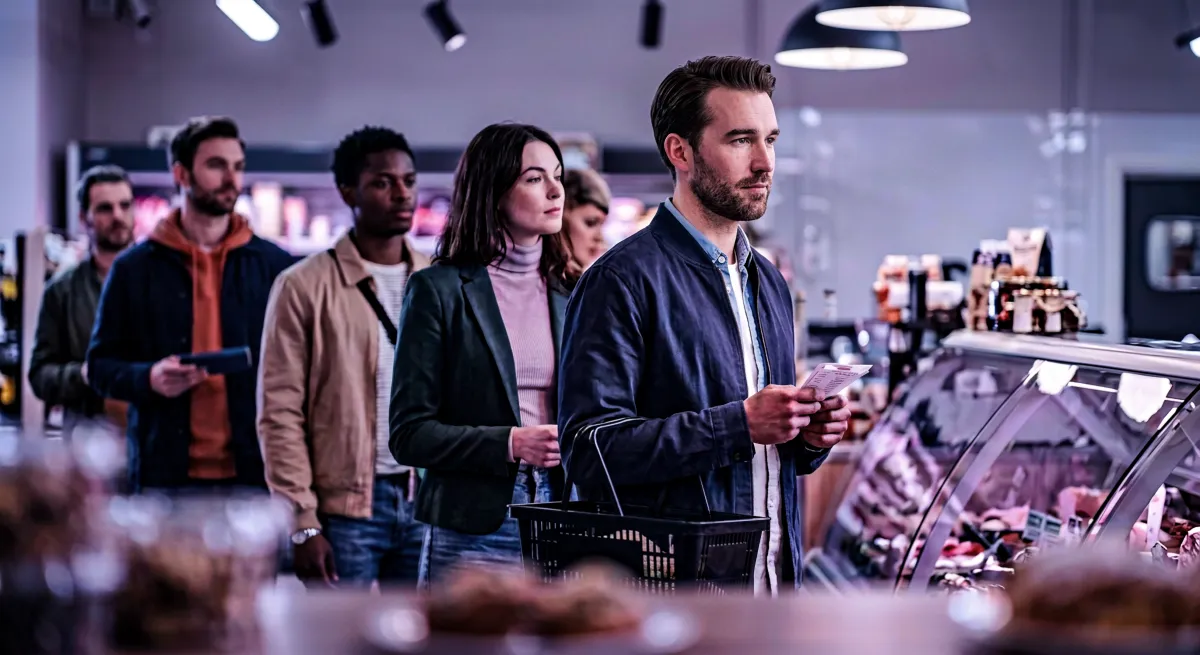 Shoppers queuing at the checkout