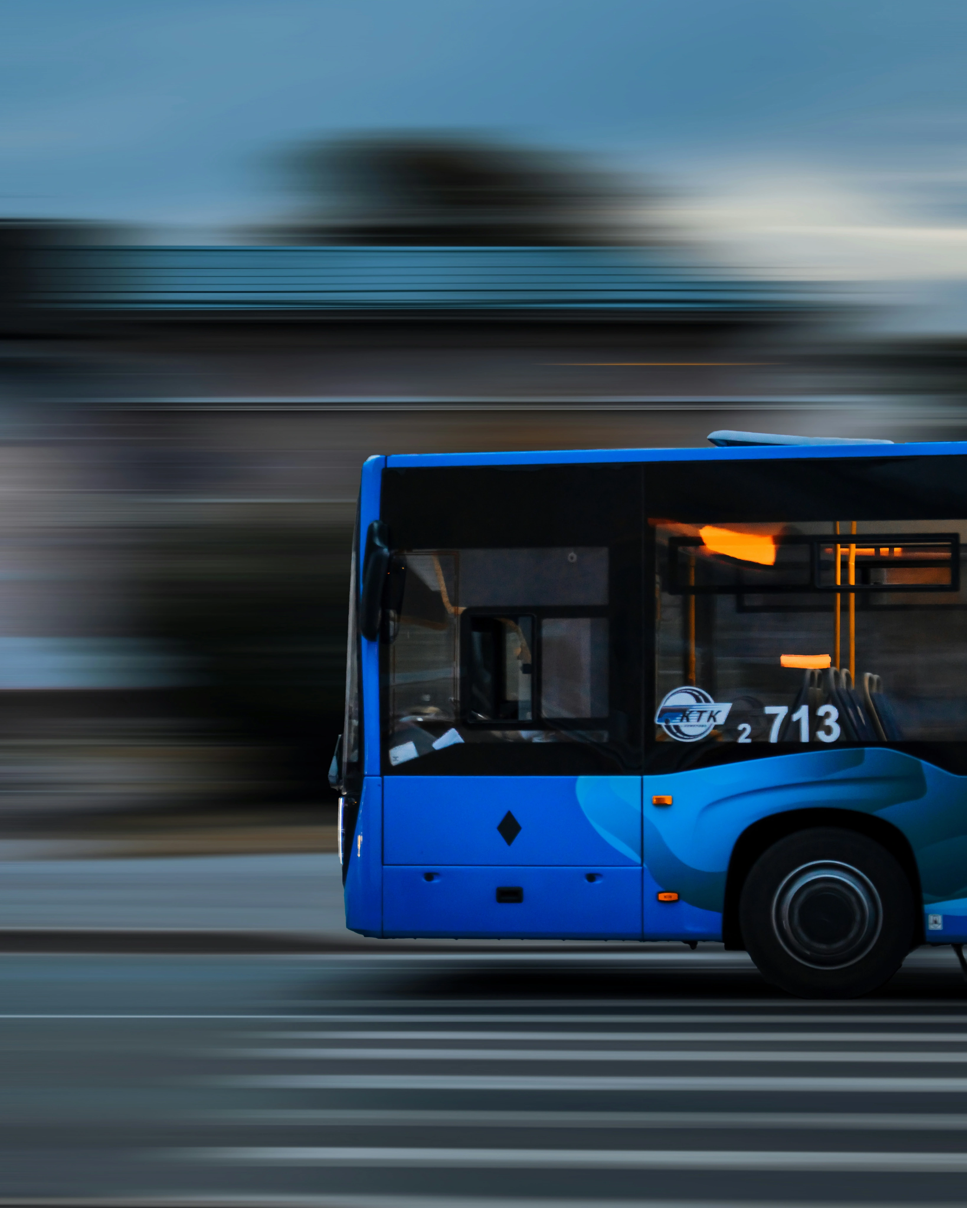 Blue electric bus in motion