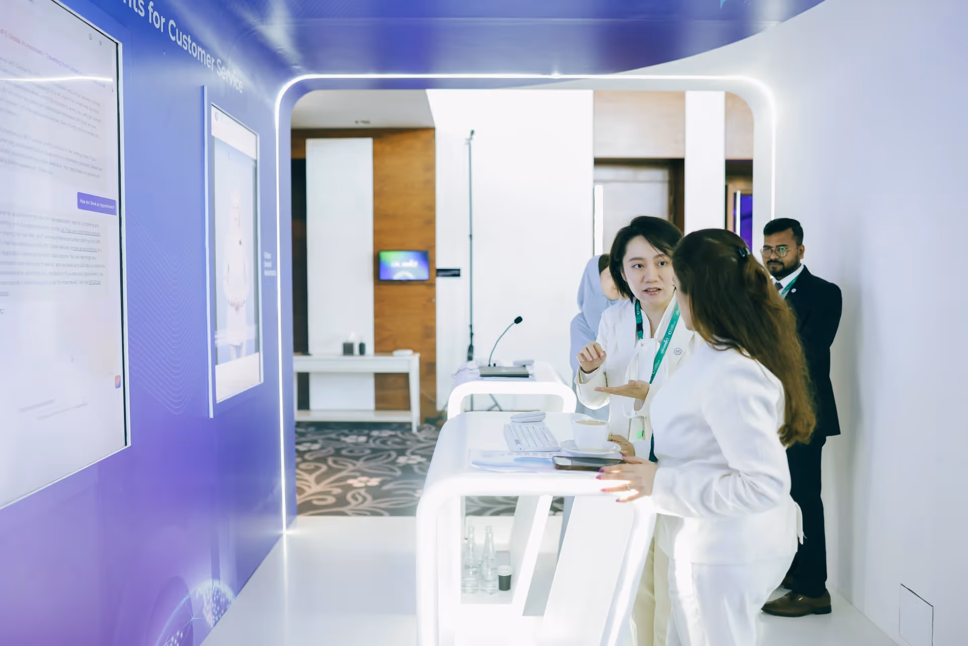 Visitors interacting with an immersive digital customer service exhibition, featuring interactive screens and a presentation area.