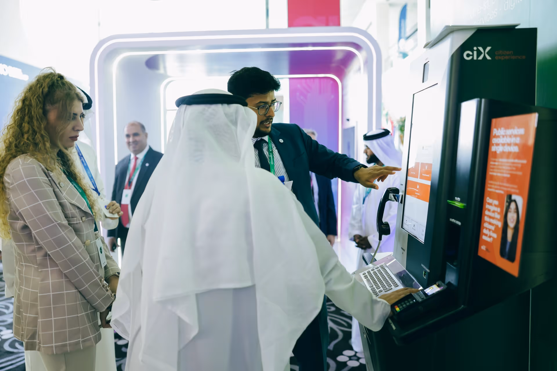 Visitors interacting with a Citizen Experience (ciX) digital kiosk at an exhibition, exploring an interactive customer service interface.
