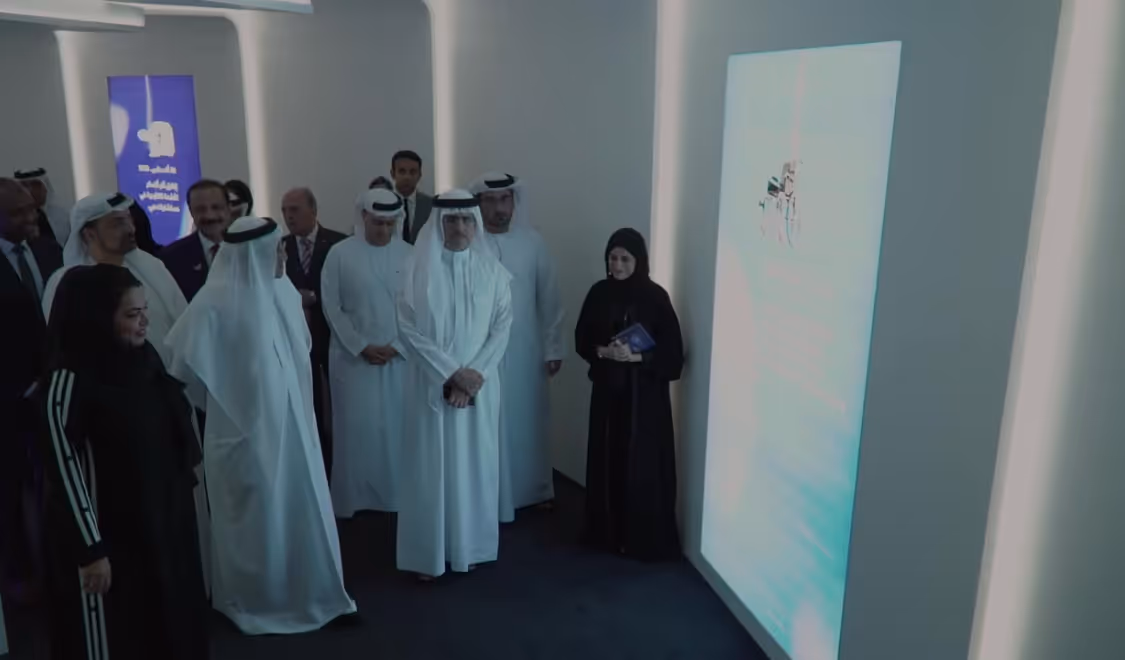 Officials viewing a digital display at a Dubai healthcare exhibition.