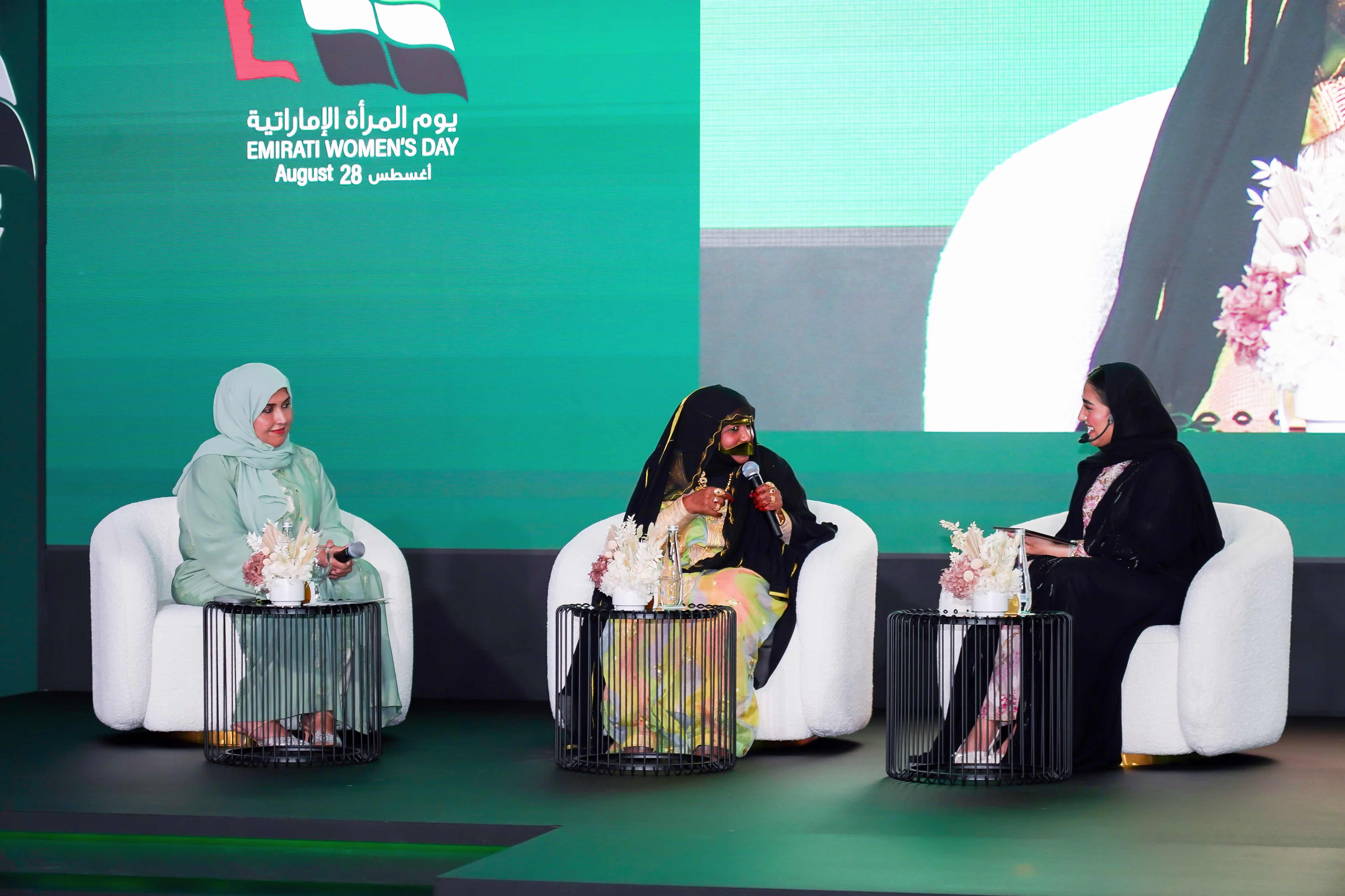 Emirati Women’s Day panel discussion with three women speakers.