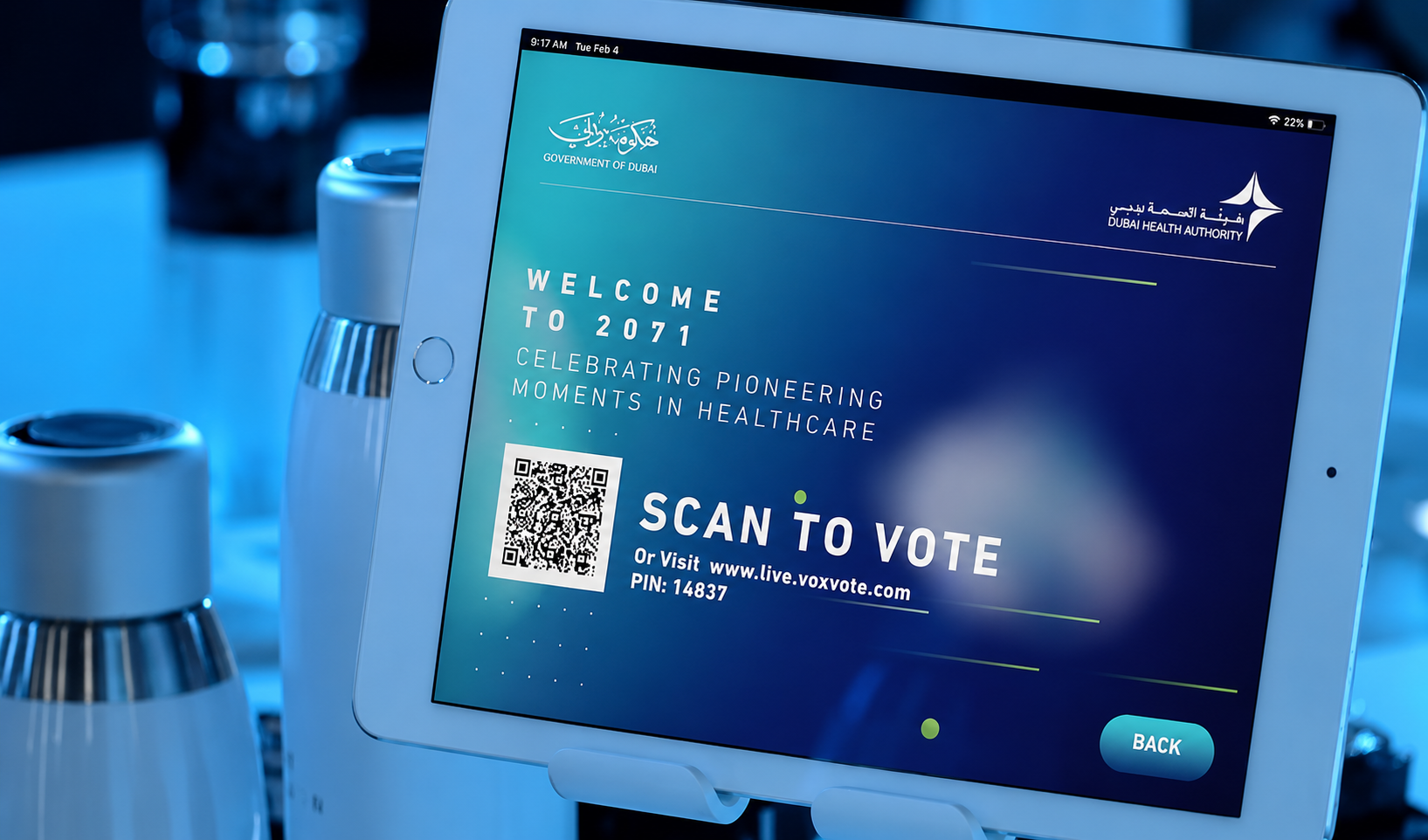 A tablet at a Dubai Health Authority event displaying a voting screen for "Pioneering Moments in Healthcare."
