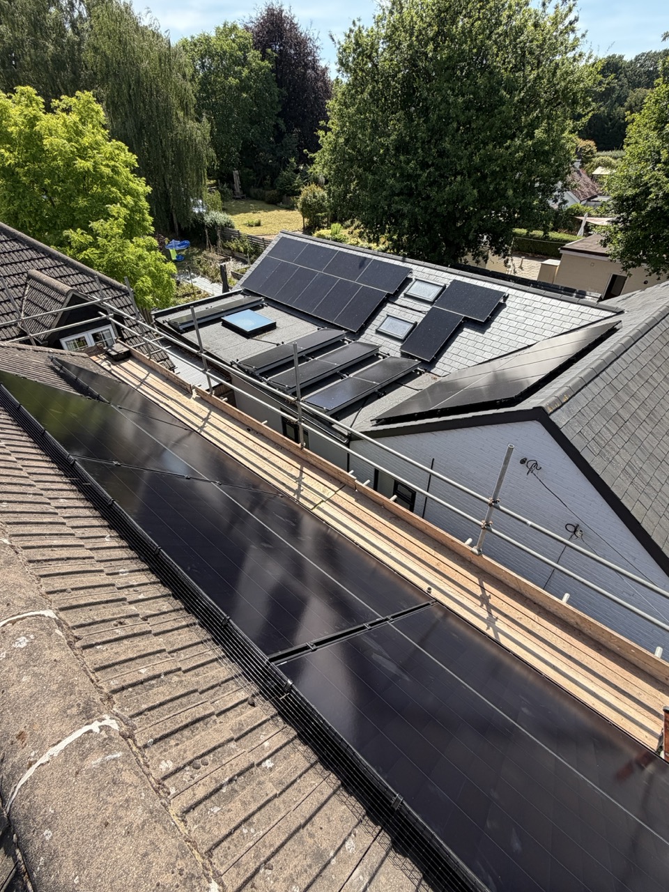 A bungalow with solar panels fitted across the full roof slope.
