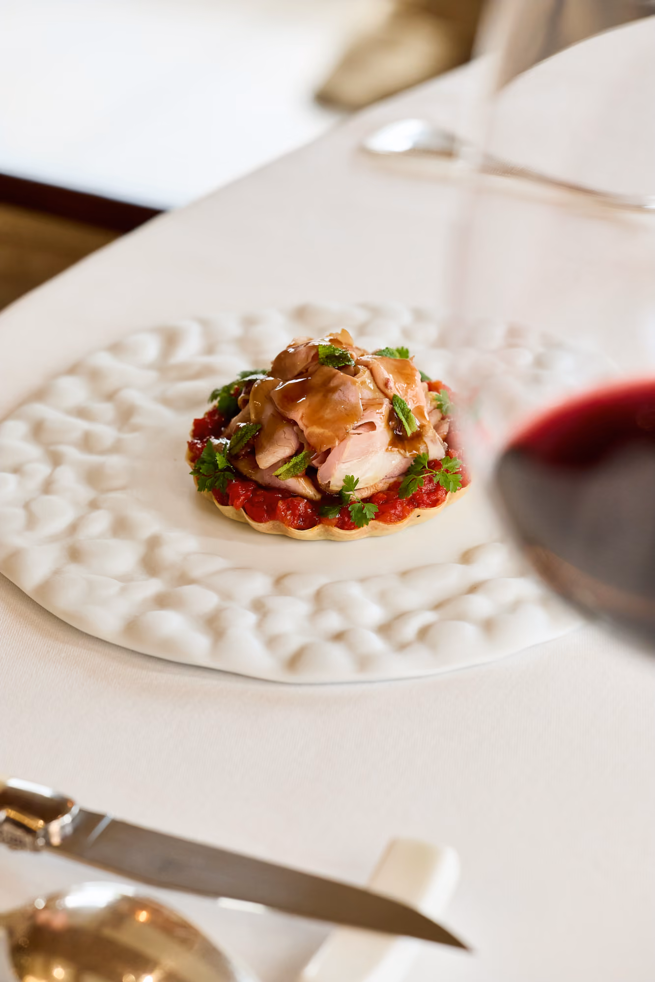 Plated dish and a glass of red wine