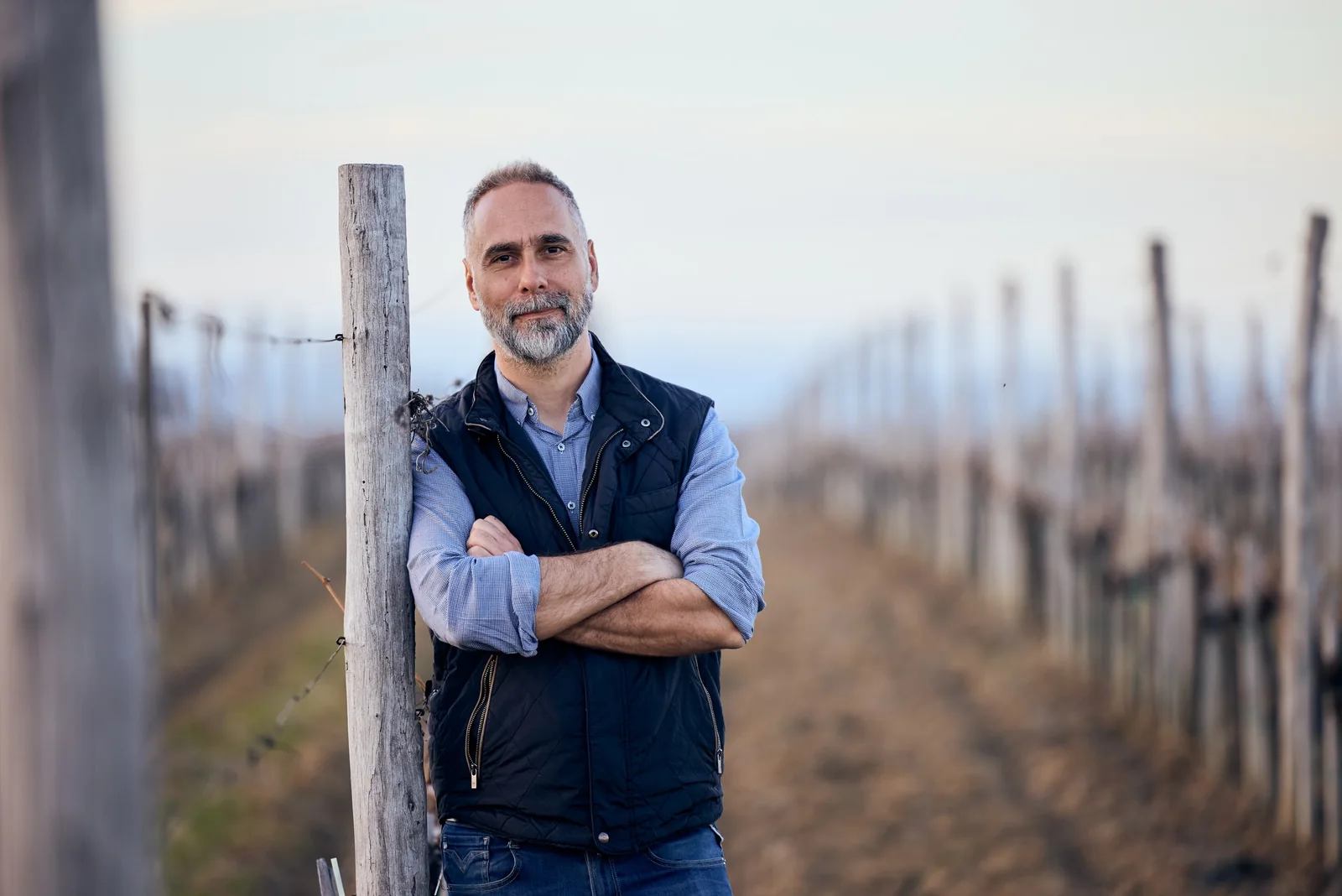 Winemaker in the winter vineyard, brand photography for a winery