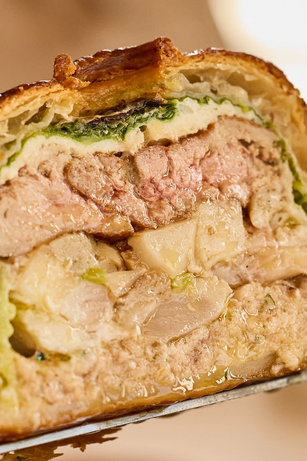 Pâté en croûte cut to show its layers, food photography for a fine dining restaurant