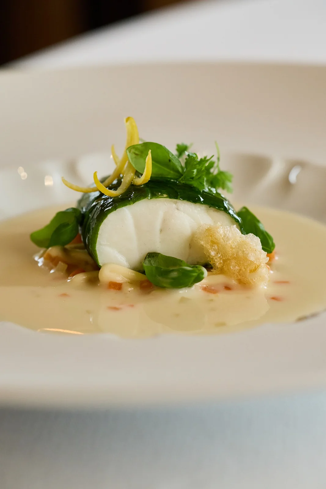 Cod wrapped in greens in a velouté, food photography for a fine dining restaurant