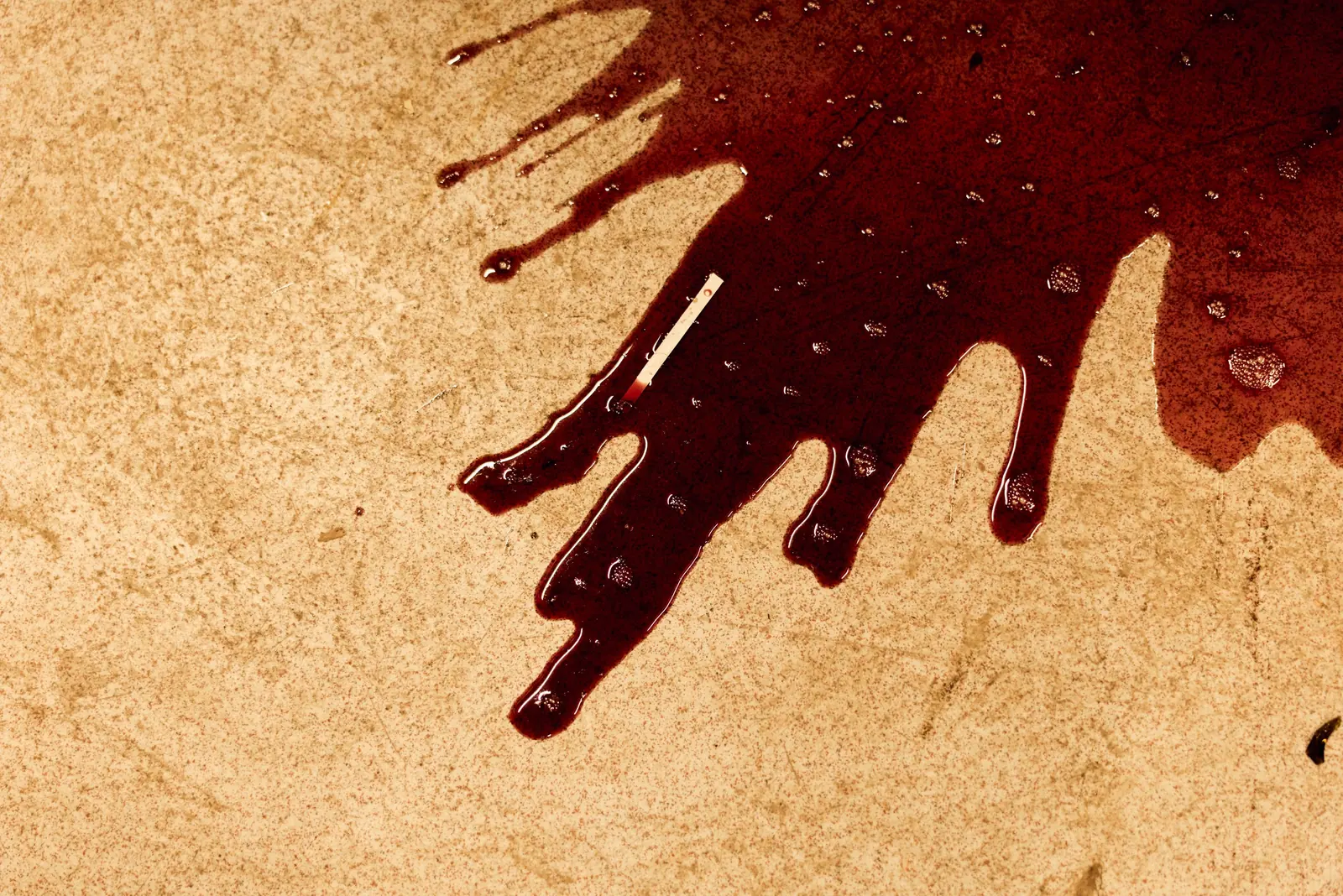 Spilled red wine on stone, brand photography for a fine dining restaurant