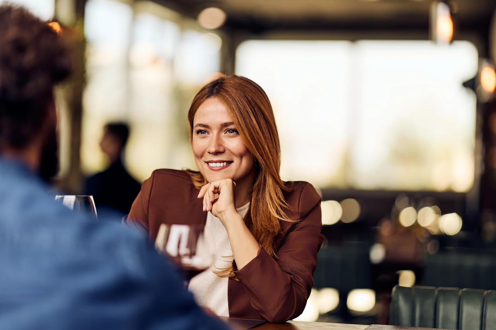 Guest across the table in the dining room, brand photography for a restaurant