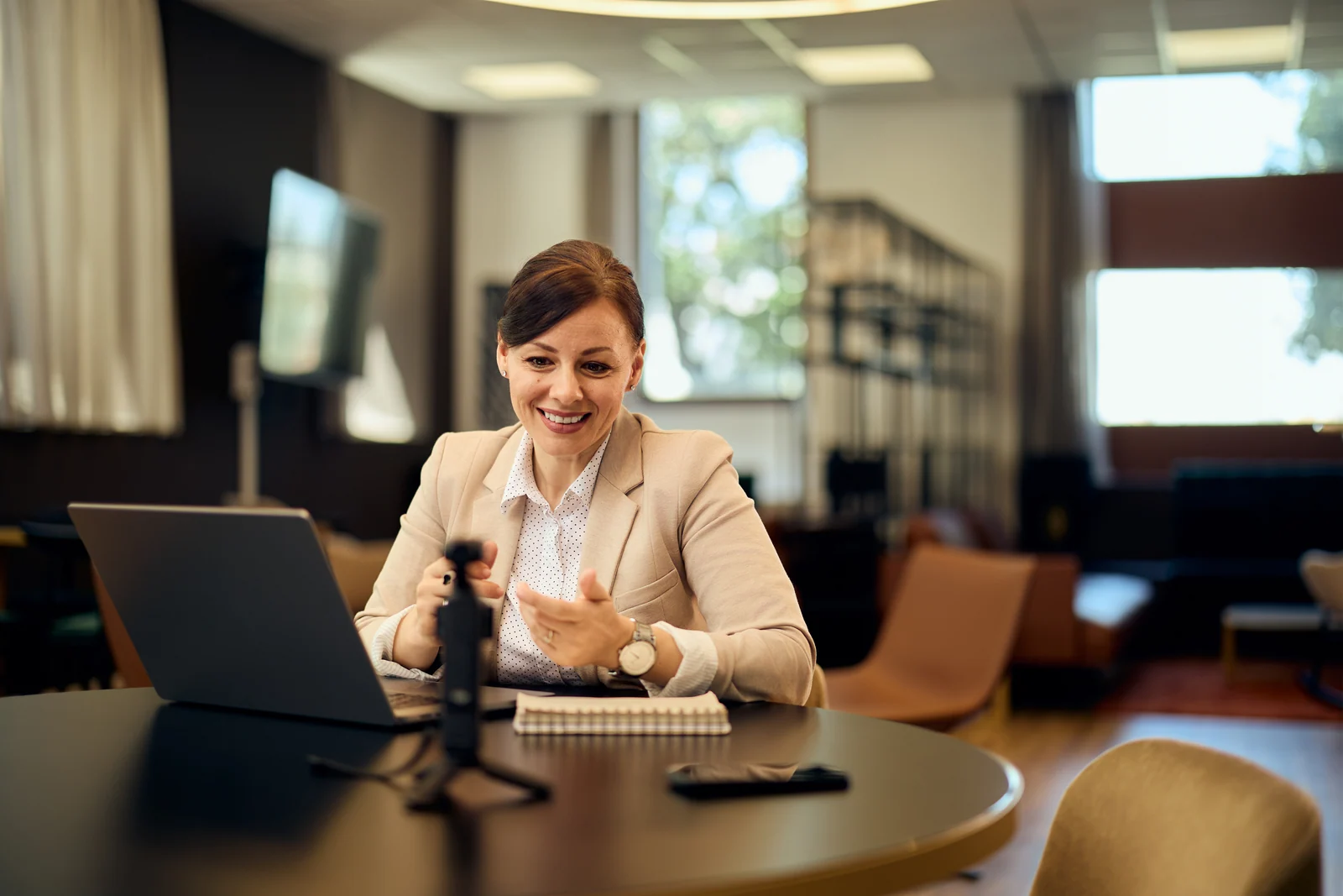 Manager on a video call from the lounge, business portrait for a professional services firm