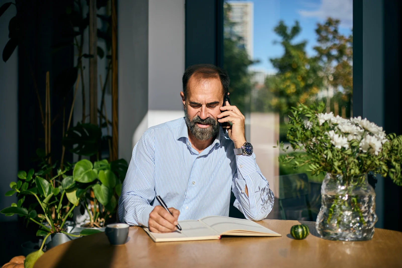 Director taking notes during a call, business portrait for a professional services firm