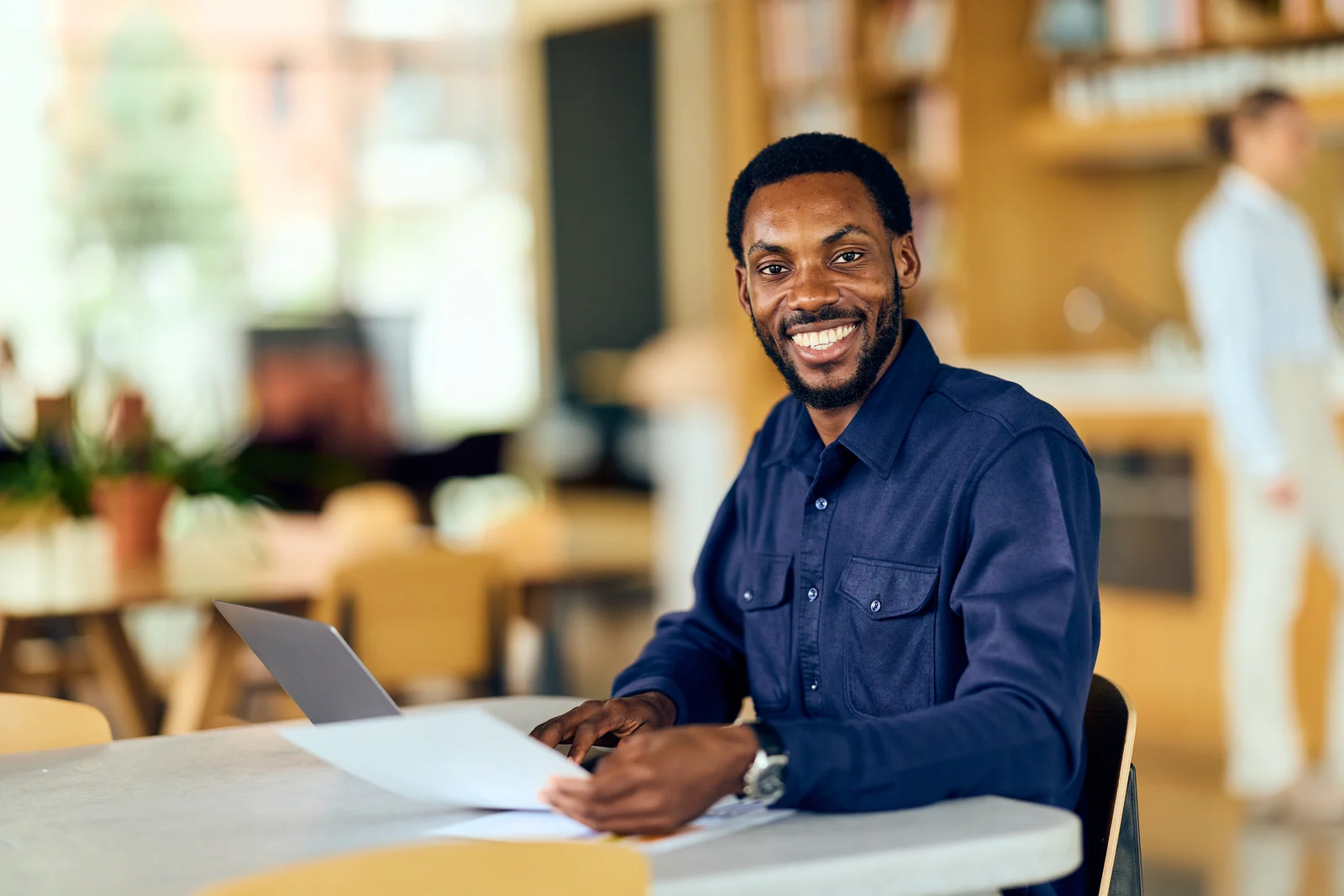 Executive at a shared workspace desk, business portrait for a professional services firm