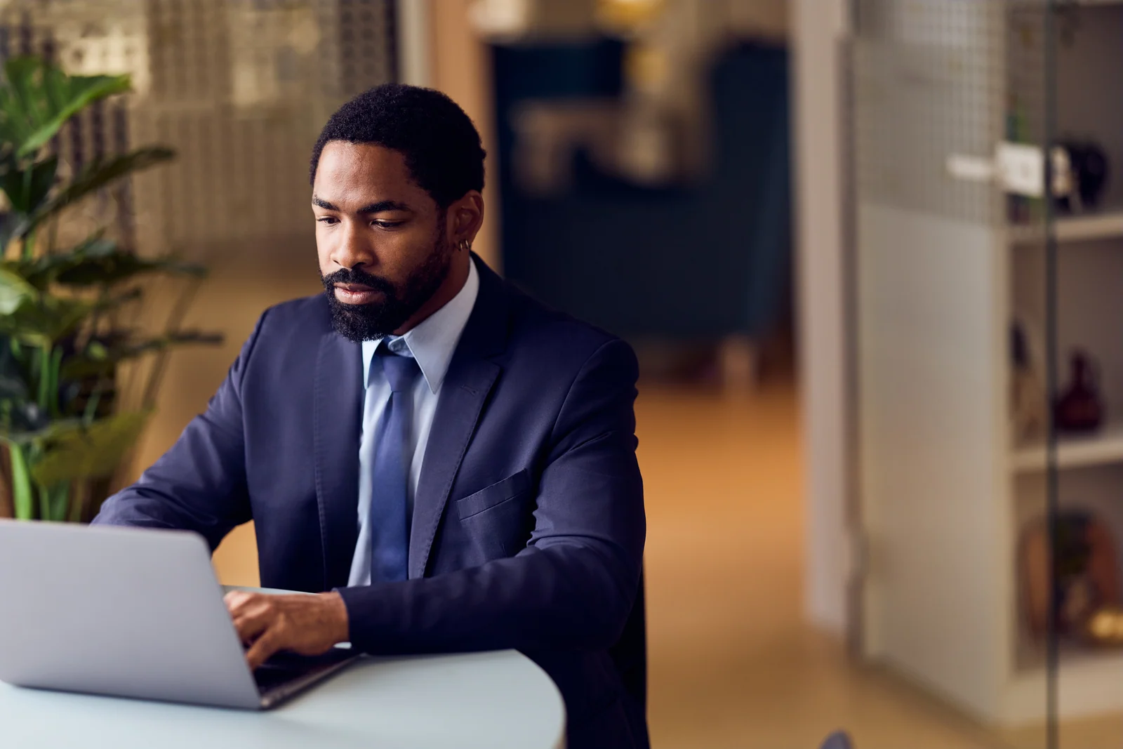 Executive working at a laptop, business portrait for a professional services firm