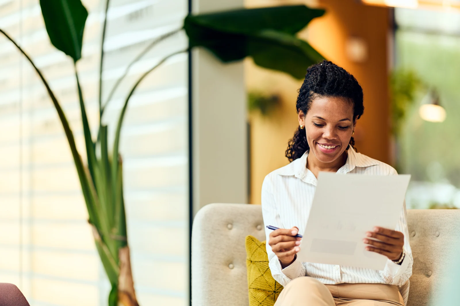 Consultant reading a document in the lounge, business portrait for a professional services firm