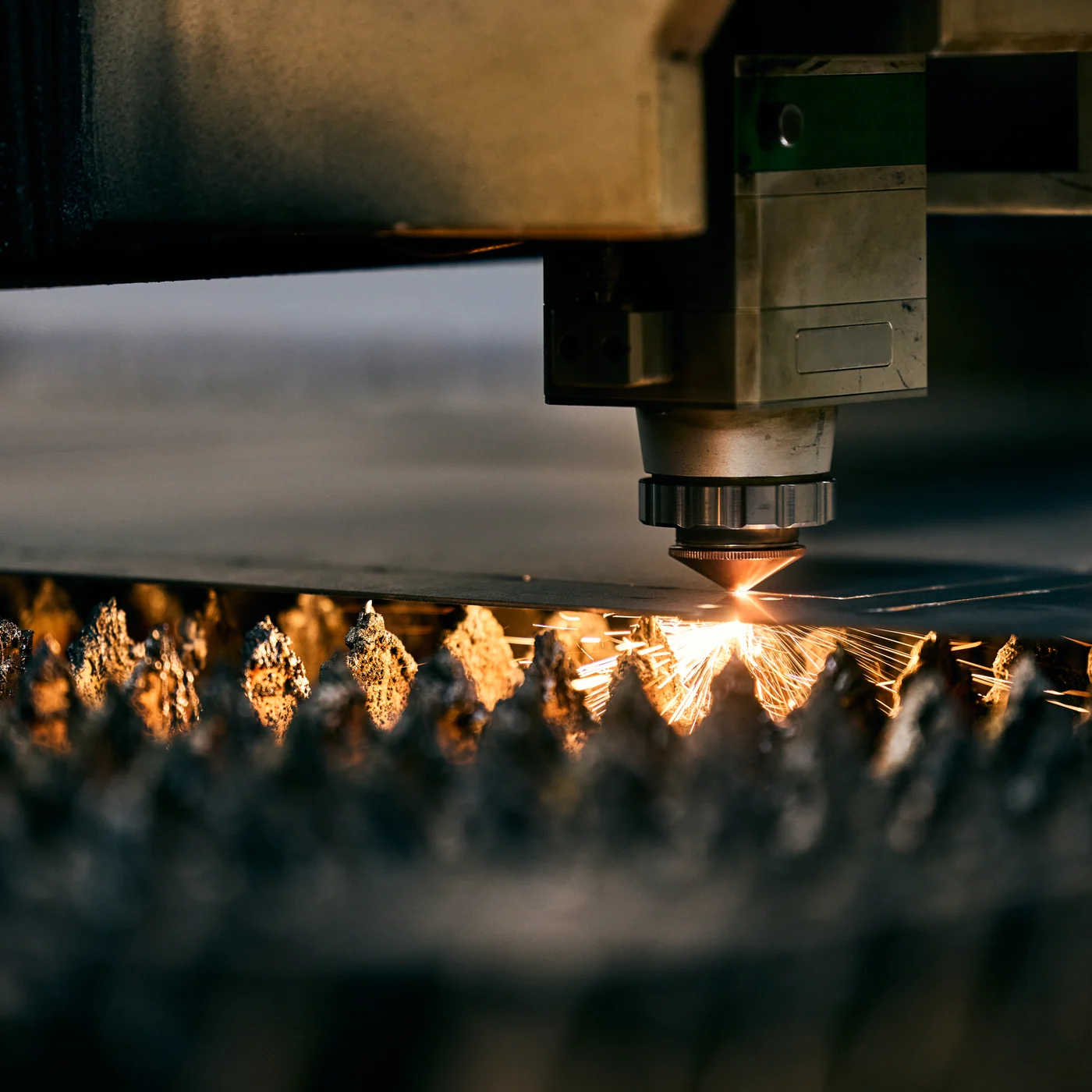 Laser head cutting sheet steel, brand photography for a manufacturer