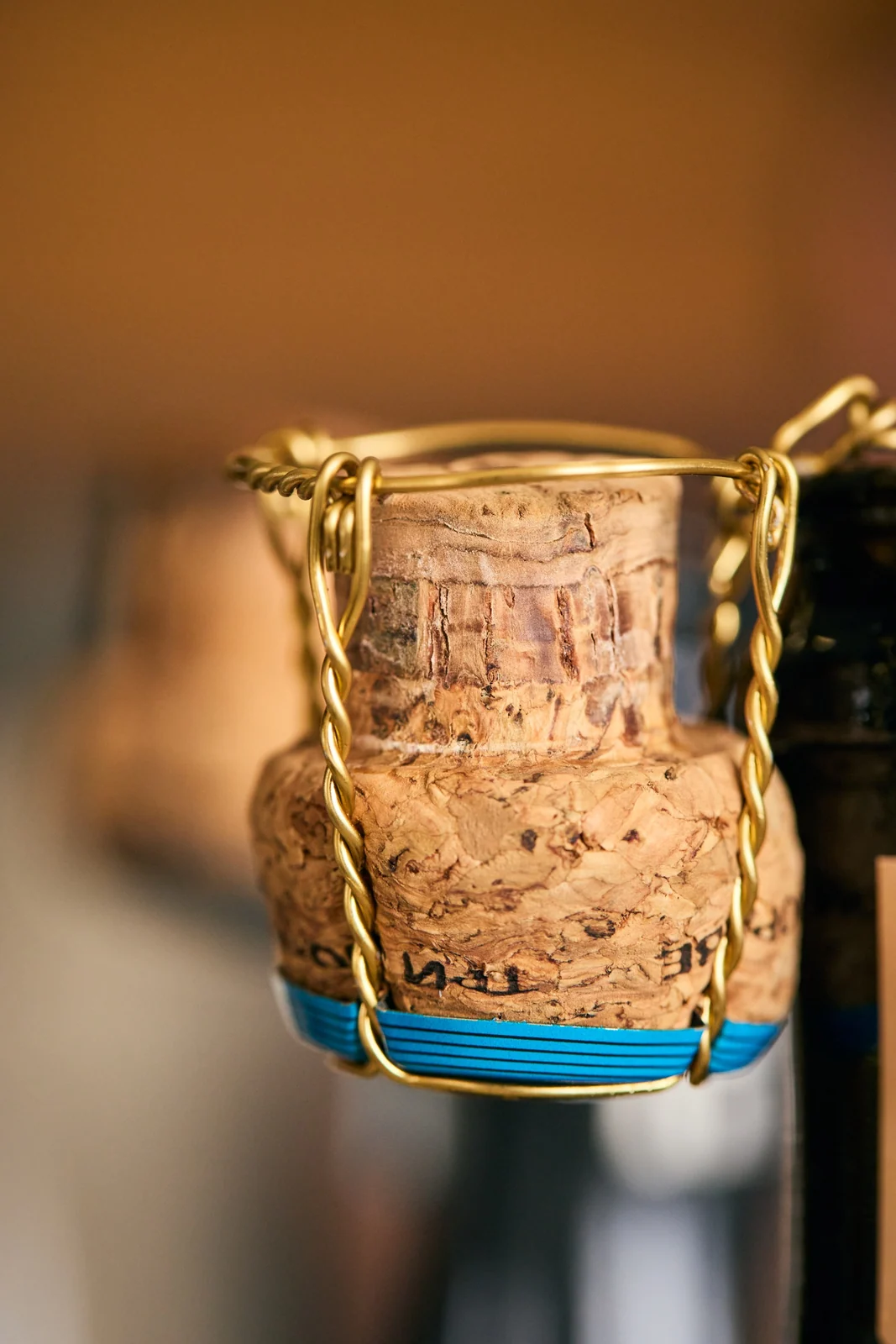 Cork and wire cage on a bottle of sparkling, brand photography for a winery