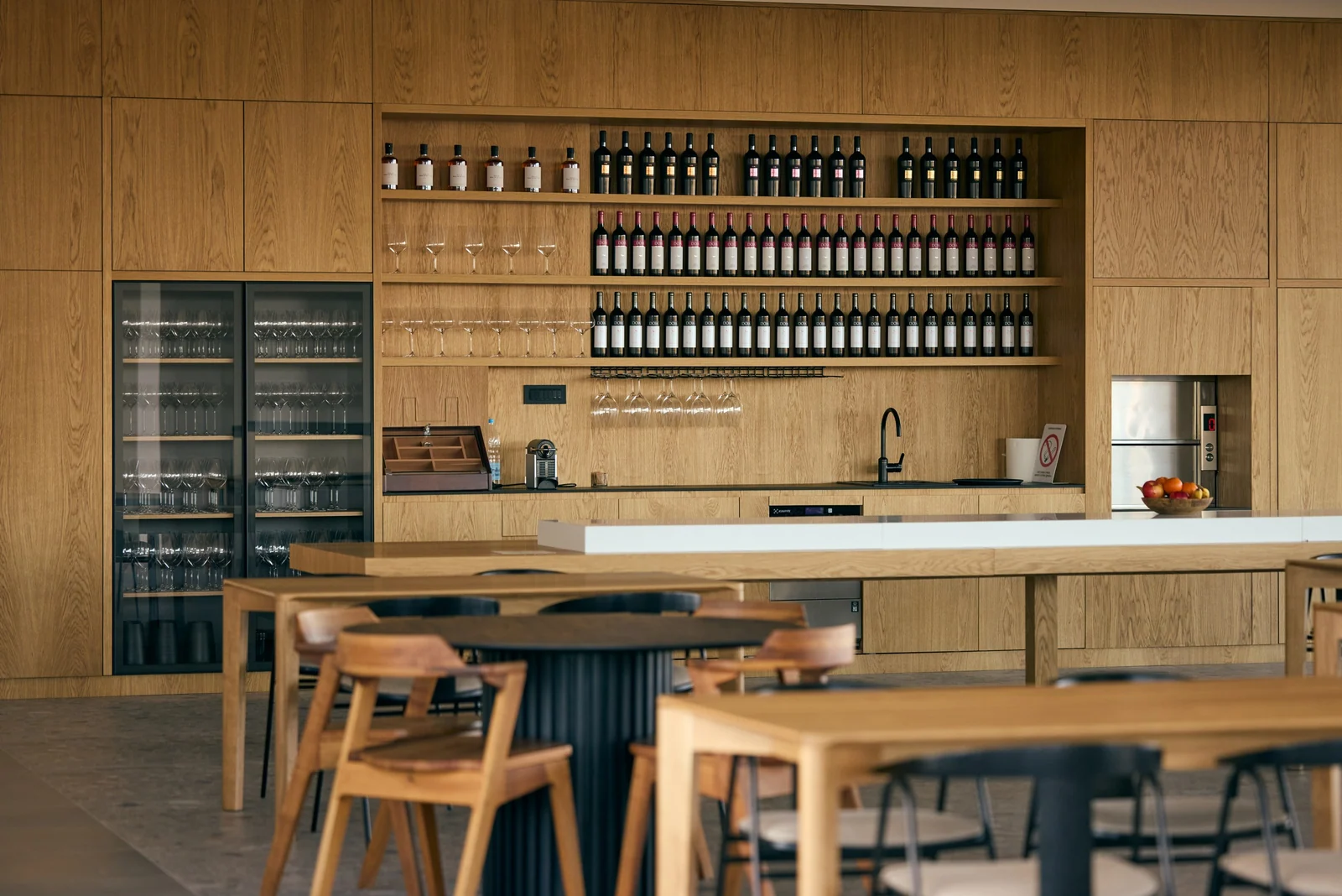 Tasting room in oak, set for a seated tasting, brand photography for a winery