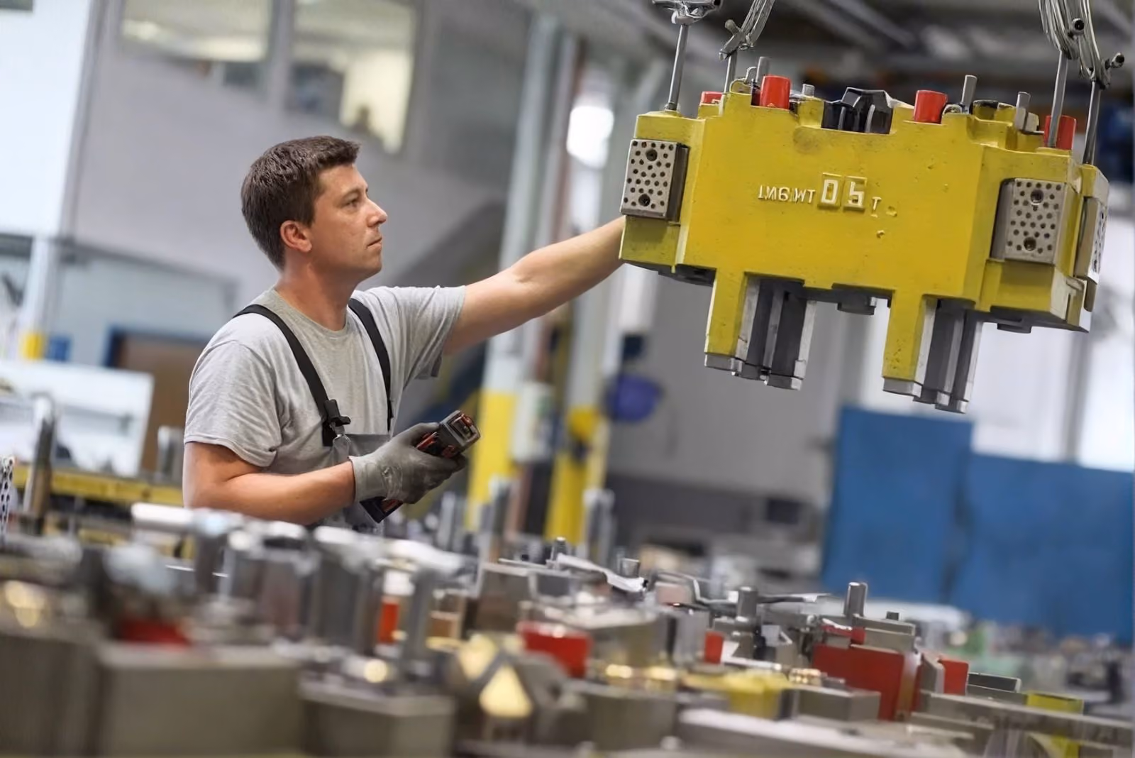 Toolmaker adjusting a large injection mould on the shop floor