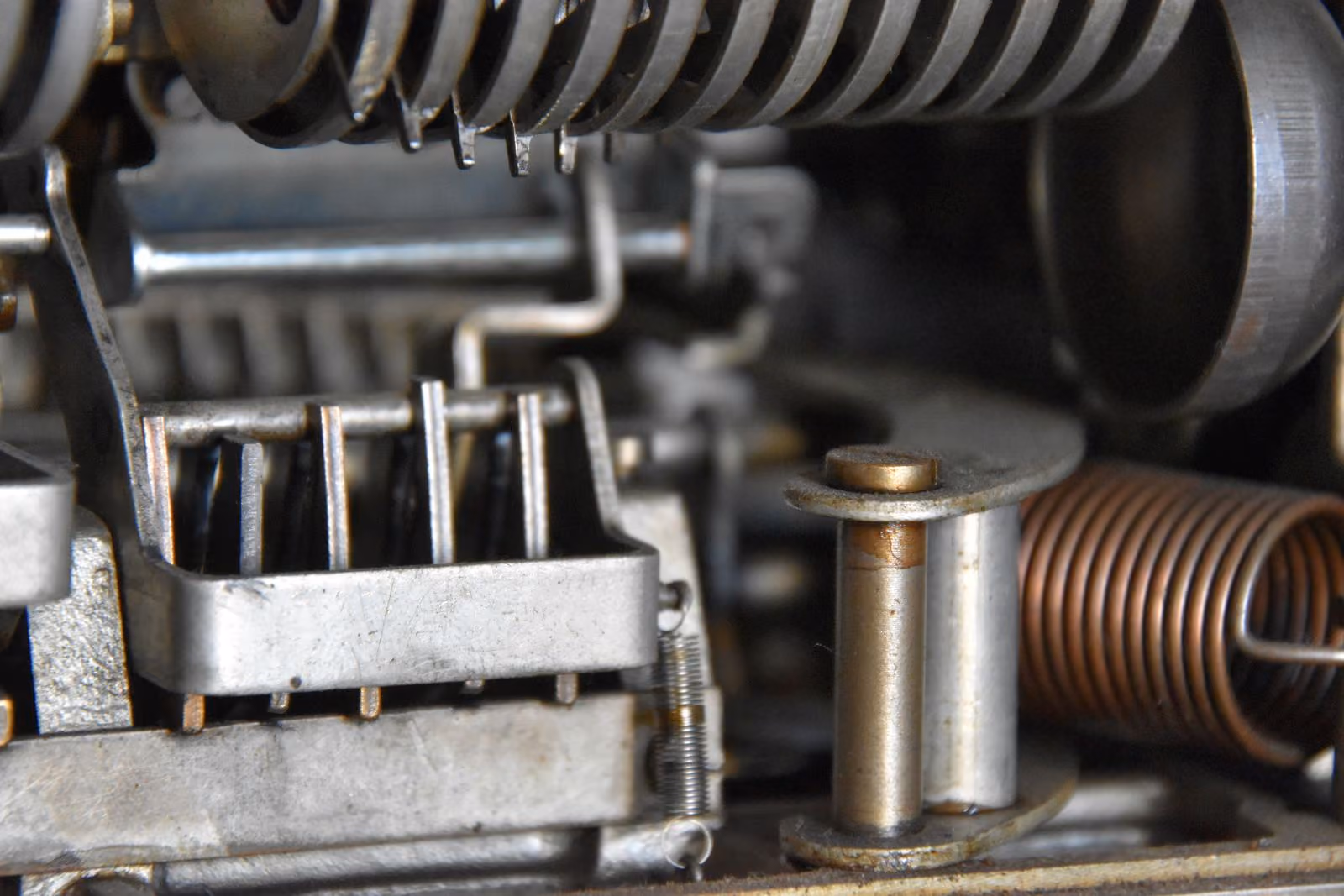 Close-up of a multi-stage mechanism with springs and stepped steel plates
