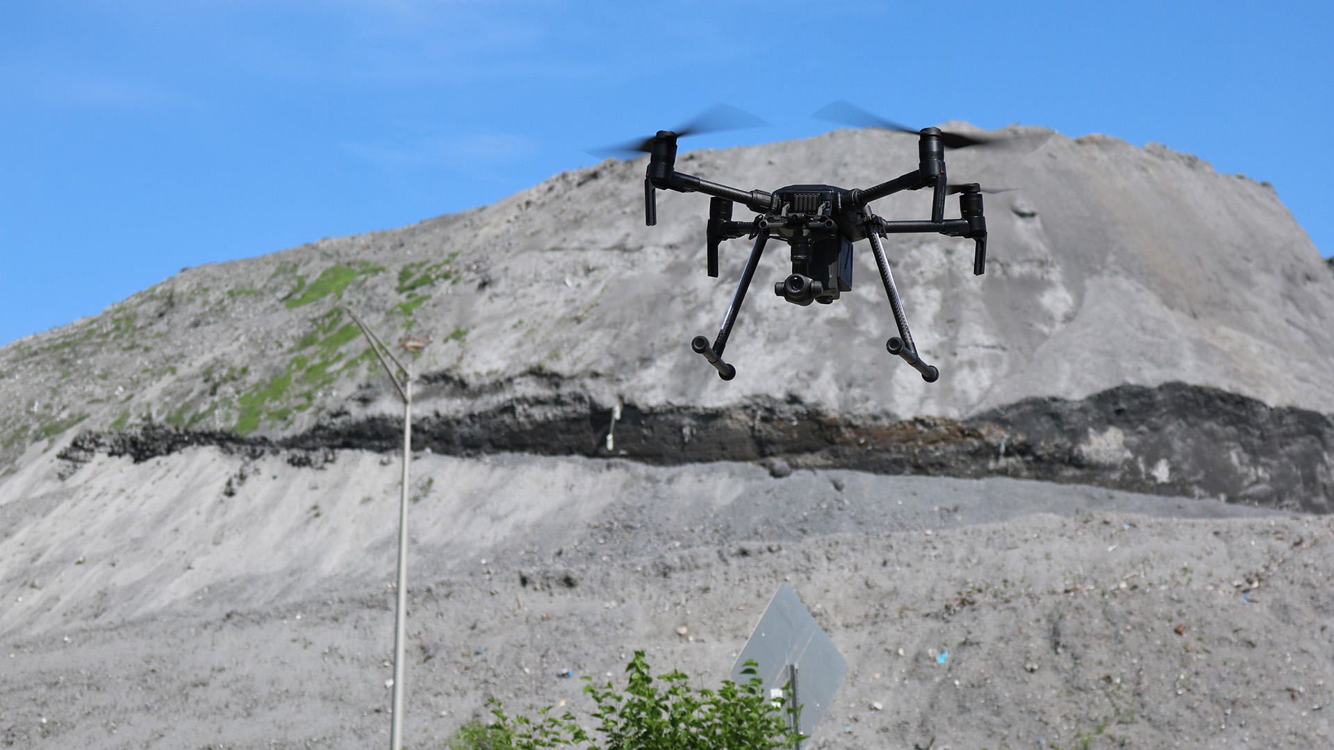 Survey drone in flight above an active construction site
