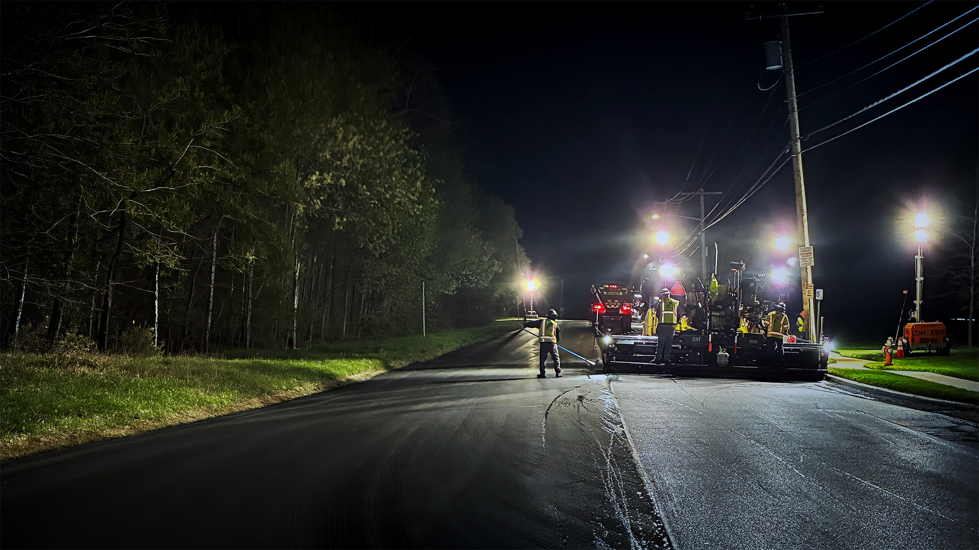 Asphalt paving operation under roadway quality assurance testing