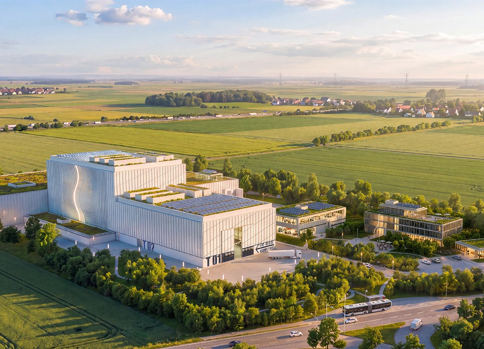A render of the Alpha site, showing a handful of buildings near some open green fields.