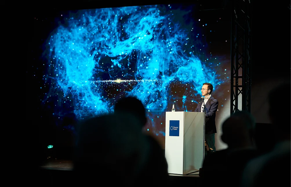 The Proxima Fusion CEO, Francesco Scortino given a keynote speech on a stage.