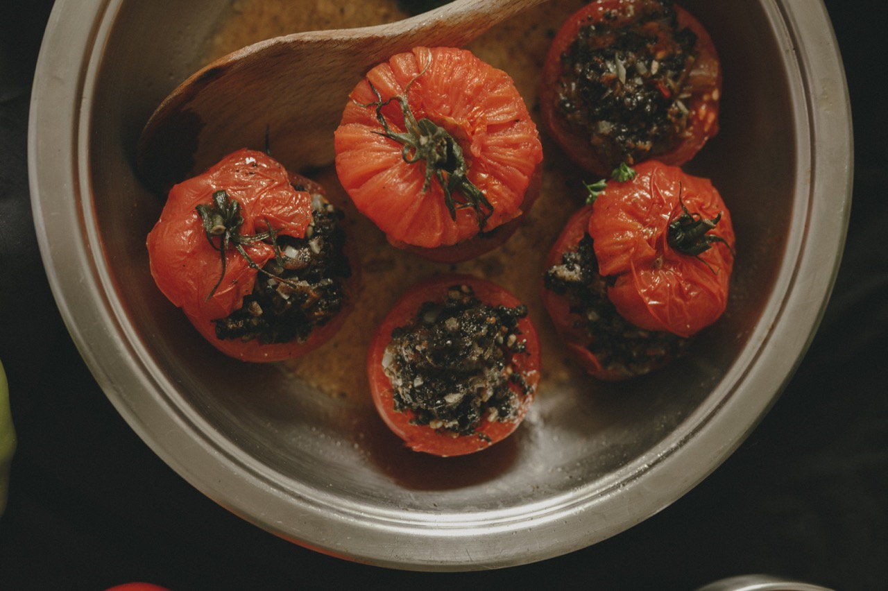 Tomates farcies à la préparation végétale Edo, dorées dans une poêle en inox, vue du dessus