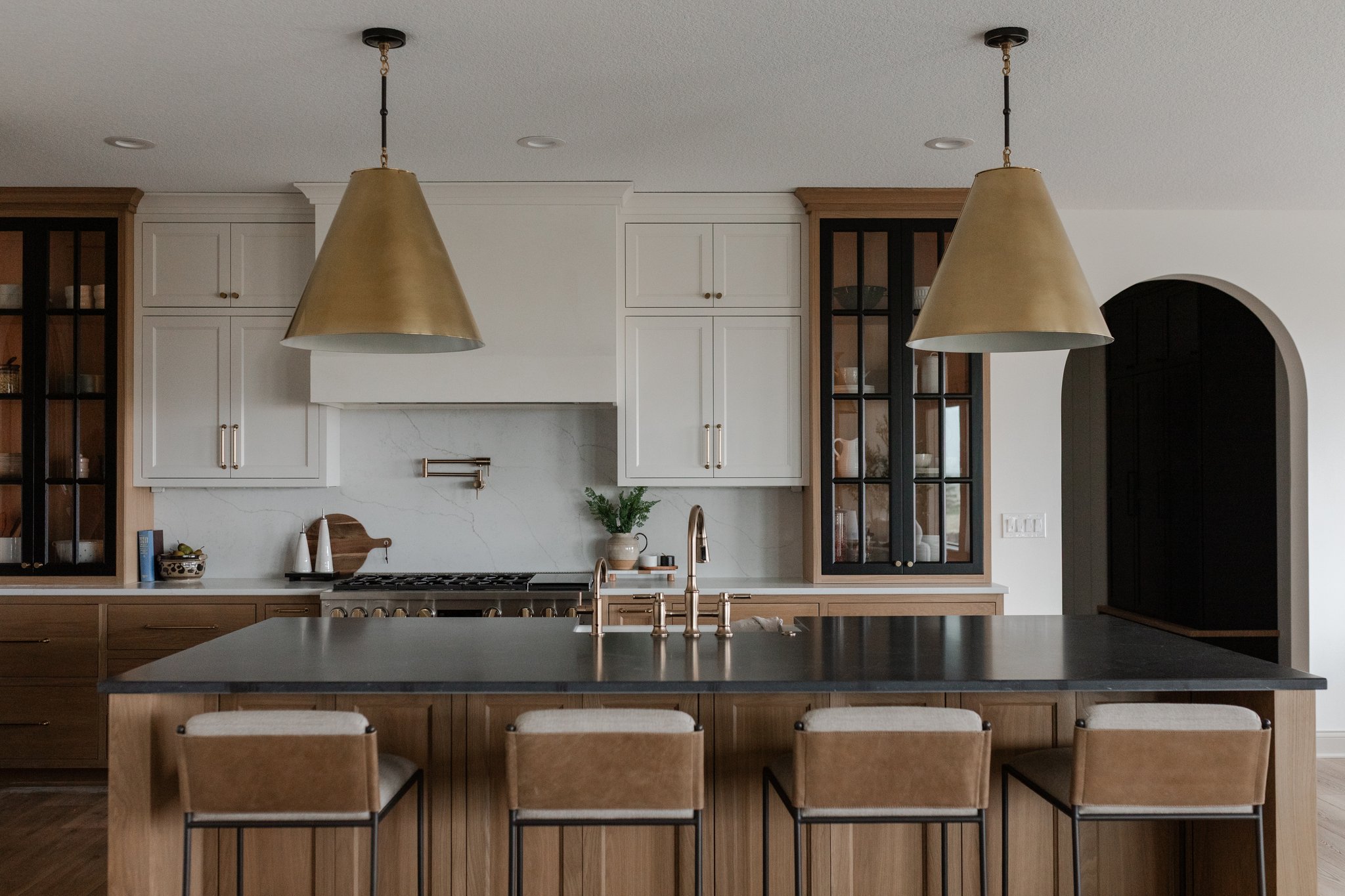Custom kitchen with brass pendants