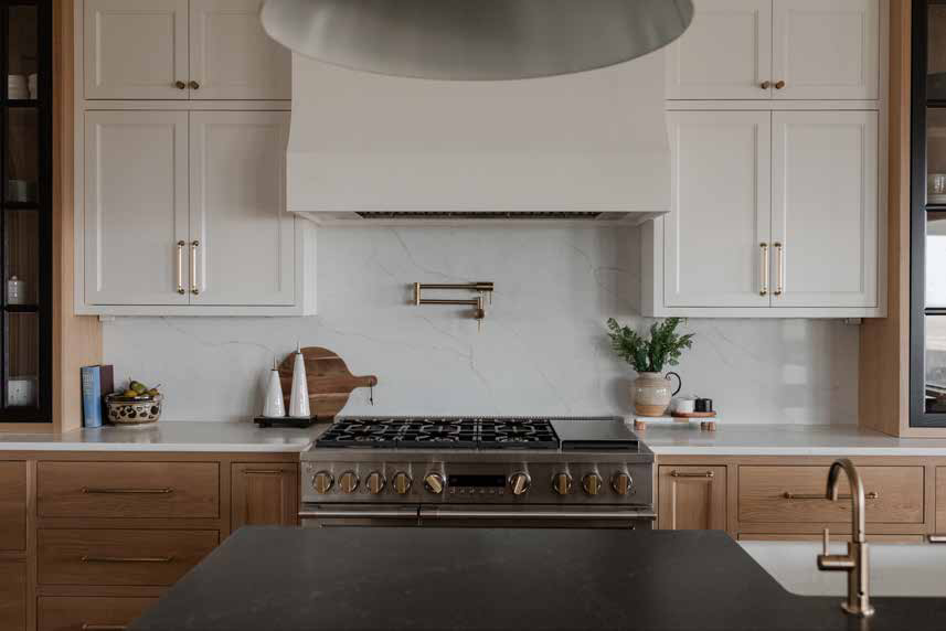 Kitchen with white cabinetry and brass fixtures