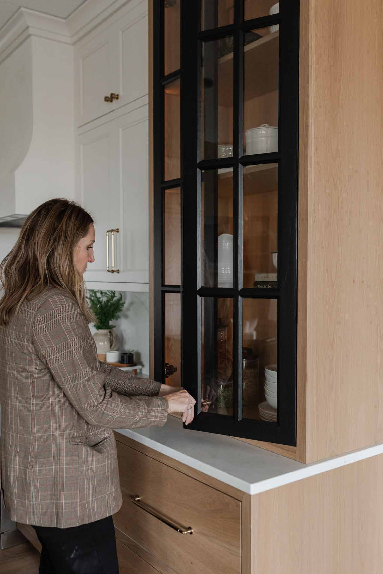 Designer at a steel-and-glass pantry door