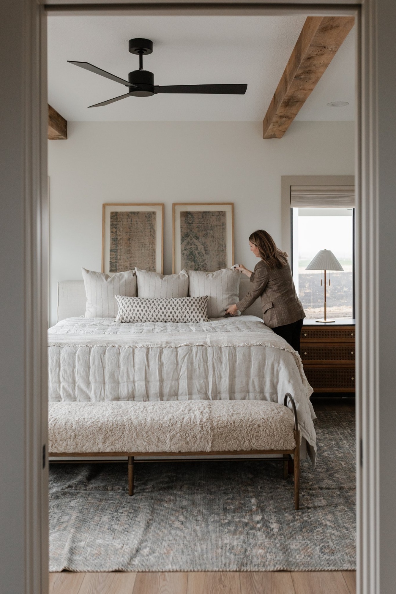 Primary bedroom being styled for handoff