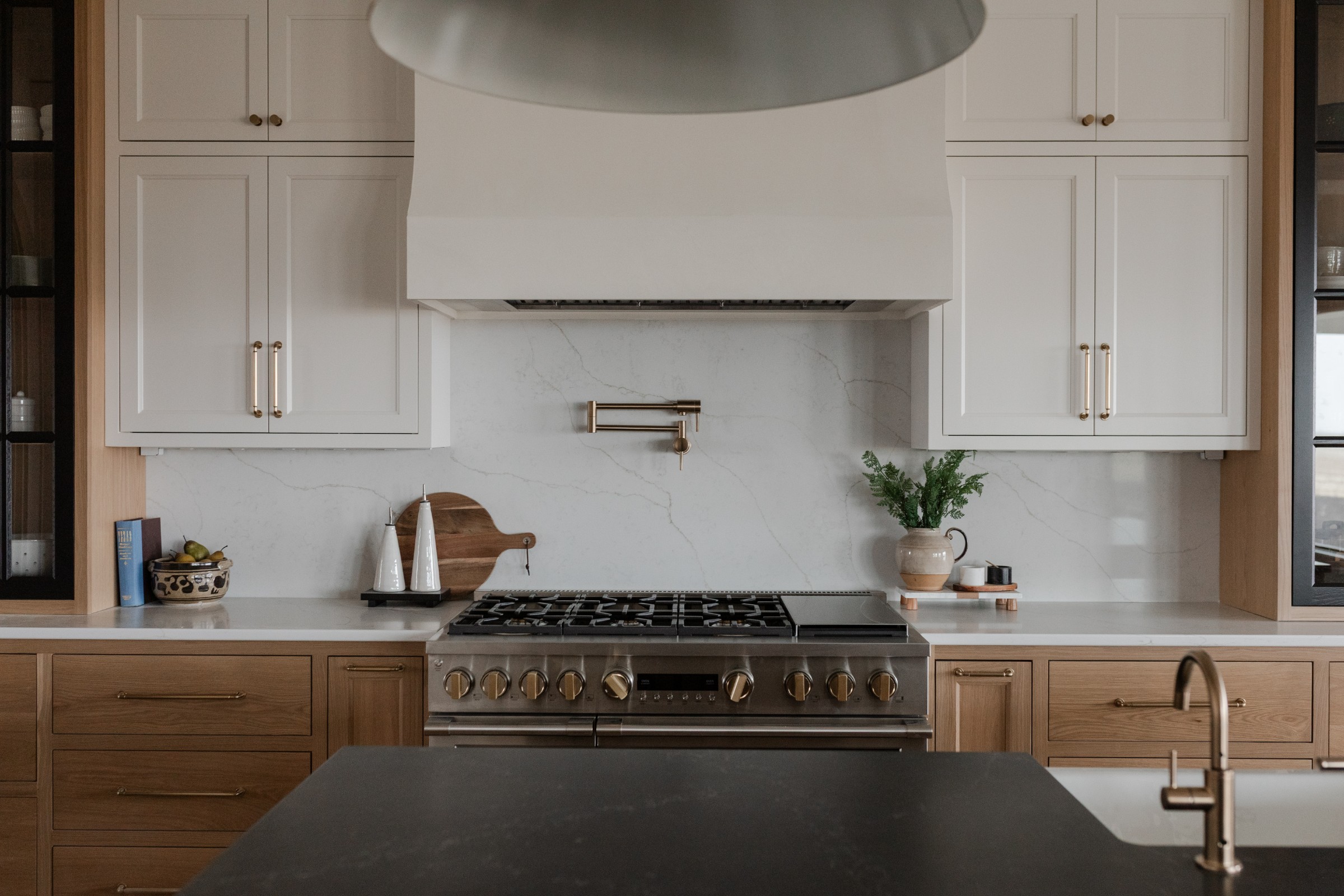 Kitchen with plaster hood and wall-mount pot filler