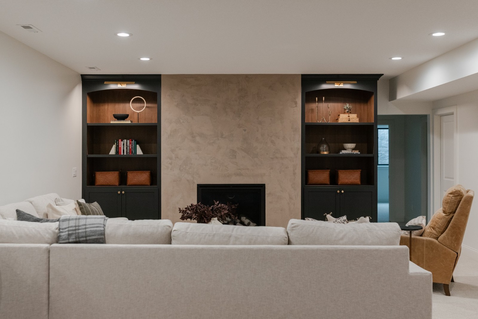 Attic lounge with dark green panelled walls and leather bench