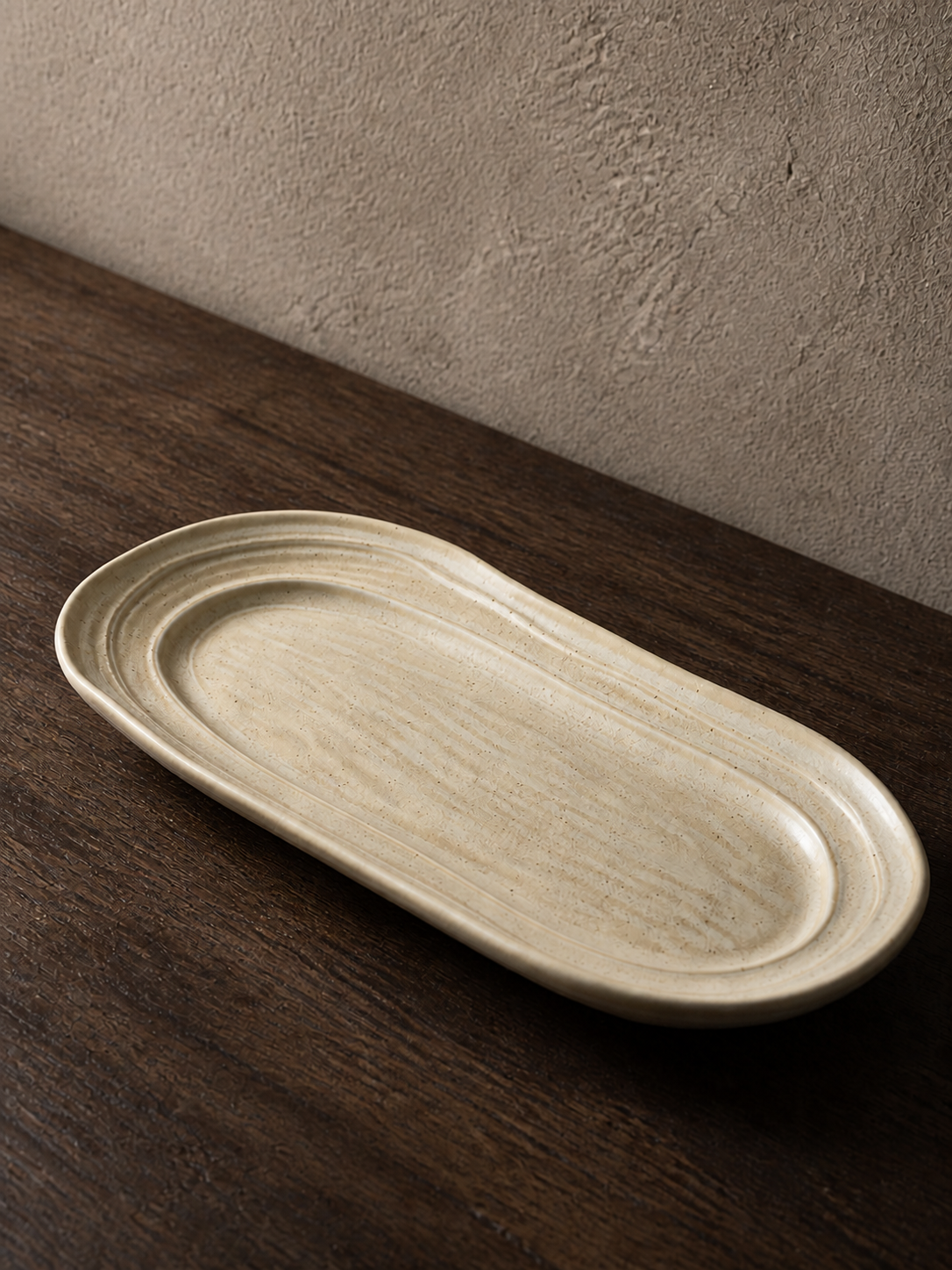 Quiet Dune oval plate showing its elongated form and flowing interior ridges