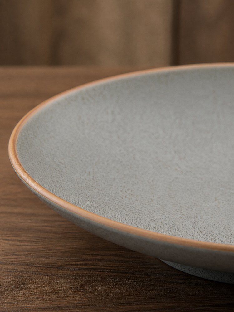 Close view of Hearthline speckled grey glaze and warm brown rim