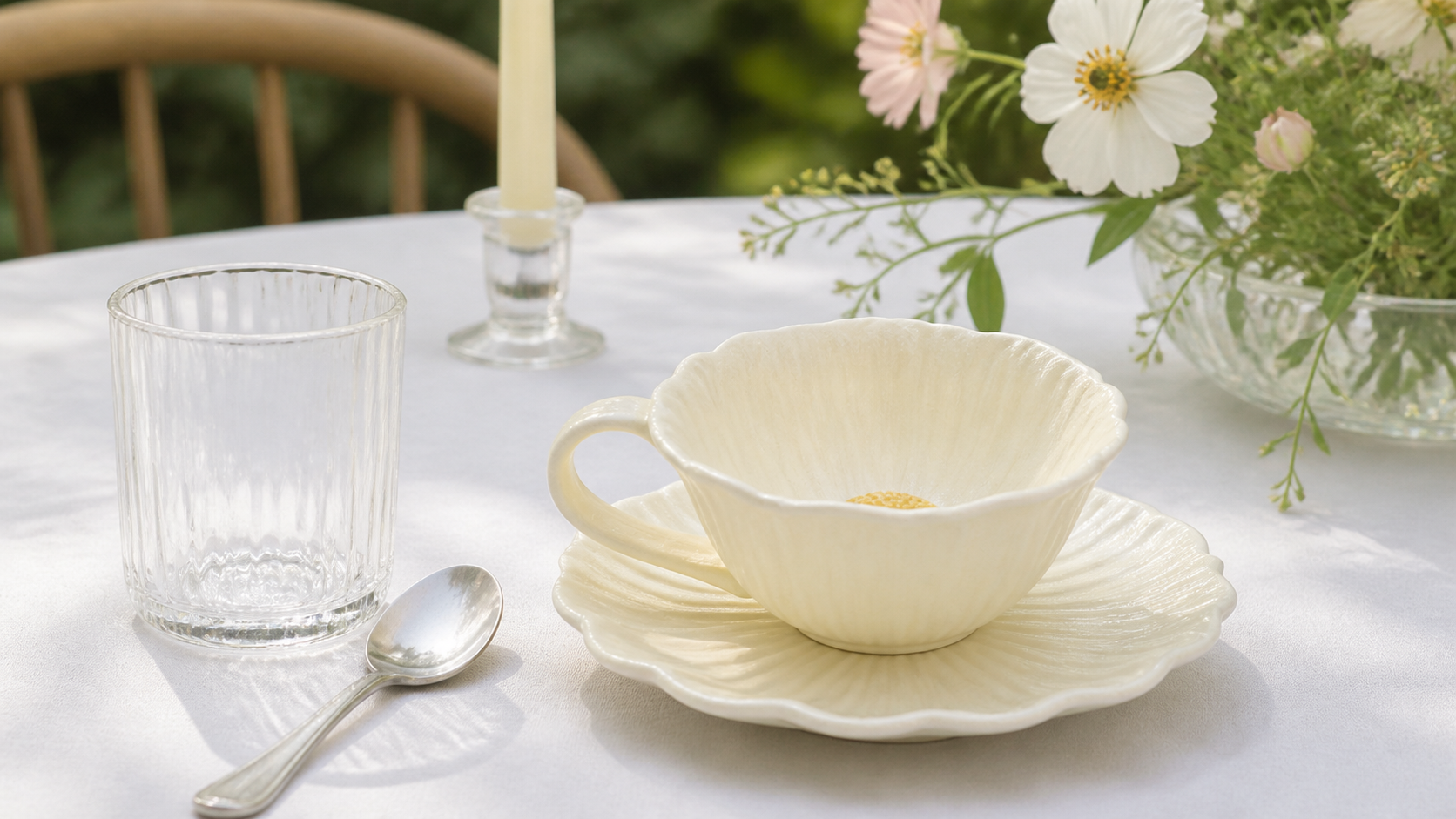 Fine Rim soft yellow place setting shown from the side in a French garden table scene