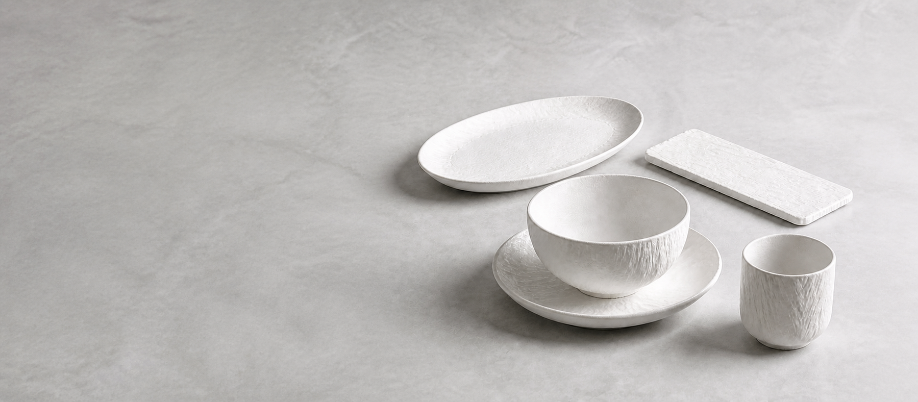 Quiet Strata approved collection visualization: five coordinated ceramic forms on a cool neutral surface