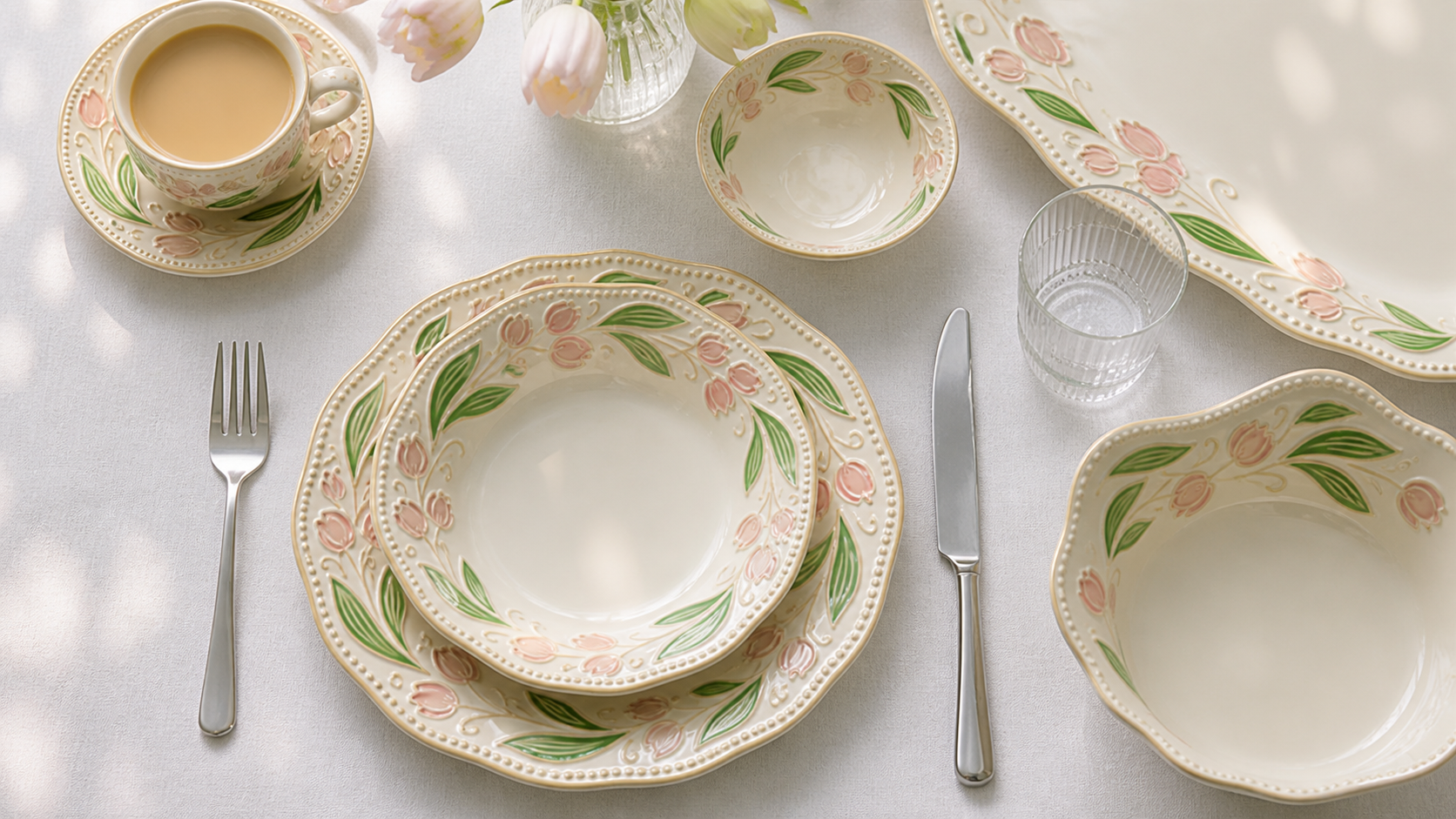 Overhead Orchard Bloom place setting with tulip motifs, cup, sauce dish and serving forms