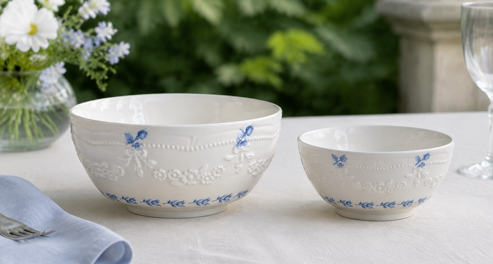 Side-by-side Willow Lace bowls showing blue floral accents and white sculpted garlands