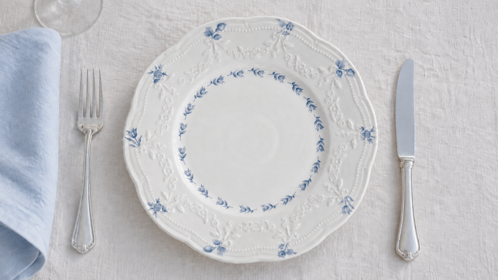Overhead Willow Lace plate detail with blue floral decoration, relief borders and silver cutlery