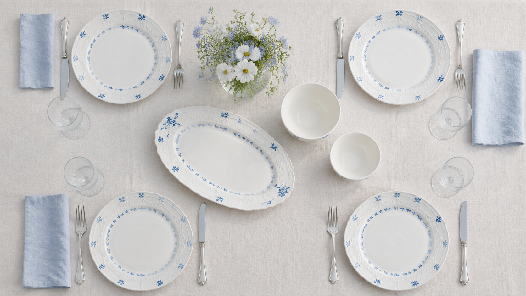 Overhead Willow Lace garden table with four place settings, two bowls and an oval serving platter