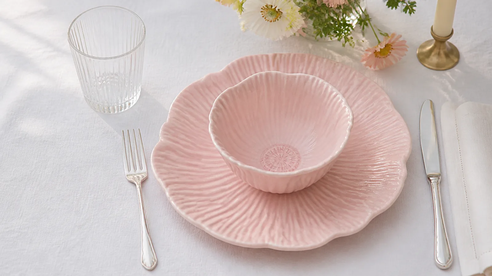 Close overhead view of a Camellia Relief blush pink bowl and plate with radiating petal relief