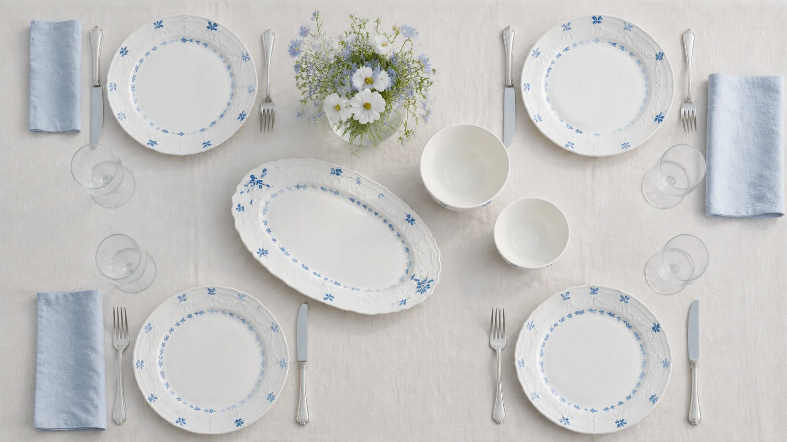 Overhead Willow Lace garden table with four place settings, two bowls and an oval serving platter